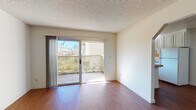 Located at 2050 Royal Dr in Santa Clara, California, this single-floor residence offers a practical and well-organized layout suited for comfortable everyday living. The main living area features warm wood-style flooring and is bathed in natural light through a large sliding glass door that opens directly onto a private balcony, offering outdoor views of the surrounding neighborhood. Baseboard heating runs along the walls, ensuring consistent warmth throughout the space. The textured ceilings are consistent throughout the unit, adding a classic residential character.

The kitchen is efficiently designed with white cabinetry, granite-style countertops, a tile backsplash, a stainless steel sink, and a white electric range. A window above the sink brings in additional natural light, making the space bright and functional.

The bedrooms are carpeted for comfort and each features sliding mirrored closet doors that enhance the sense of space. One bedroom includes a sliding glass door providing direct balcony access and views of the exterior.

The bathroom is clean and straightforward, equipped with a full tub and shower combination, white tile surround, and wood-style flooring. The overall design throughout the residence is neutral and bright, creating a versatile canvas well-suited to a variety of living arrangements.