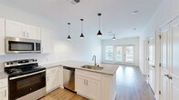 Located at 5901 Triangle Oaks Dr in Raleigh, NC, this well-designed one-bedroom, one-bathroom residence offers a thoughtfully laid-out single-floor plan with a clean, modern aesthetic. Light wood-tone flooring runs throughout the entire space, creating a warm and cohesive look.

The open-concept kitchen and living area forms the heart of the home. The kitchen features white shaker-style cabinetry, granite countertops, a subway tile backsplash, and a central island with a built-in sink and dishwasher. Three pendant lights hang above the island, adding a stylish focal point. Stainless steel appliances — including a refrigerator, range, microwave, and dishwasher — complete the well-equipped space. The living area flows naturally from the kitchen, bathed in natural light from a large window, and is fitted with a ceiling fan.

The bedroom is a comfortable, well-proportioned room with natural light streaming in through windows with blinds and a ceiling fan overhead. A dedicated closet provides convenient storage, and the room connects easily to the rest of the layout.

The bathroom includes a granite-topped vanity with white cabinetry, a tub-shower combination with tile surround, and light wood flooring consistent with the rest of the home. The overall ambiance is bright, clean, and move-in ready.