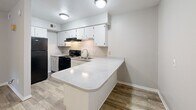 Located at 2912 Chimney Rock Dr in Nacogdoches, TX, this one-bedroom, one-bathroom unit offers a well-organized, single-floor layout designed to maximize every square foot. The kitchen is a standout feature, boasting crisp white cabinetry, light speckled countertops, a black gas range, dishwasher, and a built-in peninsula that doubles as a breakfast bar or prep space. Wood-look flooring runs throughout the unit, providing a cohesive and easy-to-maintain surface across all rooms. The living area benefits from natural light filtering in through windows, visible in the doll-house view, and a ceiling fan adds both style and comfort. The bedroom is a comfortable, well-proportioned space with its own ceiling fan, a window overlooking the greenery outside, and direct access to both a dedicated closet and the full bathroom — offering a practical and private layout. The bathroom features a full tub and shower combination with clean white surroundings and brushed nickel fixtures. Neutral gray and beige wall tones throughout the unit create a calm, versatile backdrop suitable for a variety of décor styles. This unit presents a functional and tidy living space well-suited for individuals or couples seeking simplicity and convenience in Nacogdoches.