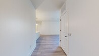Located at 2490 N Druid Hills Rd in Atlanta, Georgia, this well-appointed 2-bedroom, 2-bathroom residence offers a thoughtfully designed single-floor layout with a clean, modern aesthetic throughout. Light wood-style flooring flows continuously across the living spaces, complementing the bright white walls and creating a cohesive, airy atmosphere.

The open-concept kitchen and living area serves as the heart of the home. The kitchen features warm wood cabinetry, a white quartz peninsula with an undermount sink, white subway tile backsplash, stainless steel appliances including a French door refrigerator and microwave, and stylish globe pendant lights that add a contemporary touch.

The primary bedroom is generously sized, offering ample space and natural light. The second bedroom includes a large window with views of the surrounding neighborhood. Both rooms are served by two dedicated closets for convenient storage.

The two bathrooms are finished with modern fixtures and light wood-tone vanities with white quartz countertops. One bathroom features a tiled tub-surround with a curved shower rod, while the other includes a glass-enclosed tiled shower and a bold-framed mirror, reflecting a sleek, updated design sensibility.

A welcoming entry hallway with a smart thermostat panel and well-placed overhead ventilation rounds out this clean, move-in-ready residence in Atlanta.