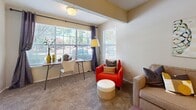 Located at 100 Riverset Lane in Memphis, Tennessee, this single-floor, 2-bedroom, 2-bathroom residence offers a well-organized layout with a variety of functional living spaces. The galley-style kitchen features dark cabinetry, black appliances including a range and refrigerator, and wood-look flooring that flows toward an adjoining dining room. The dining area is carpeted and lit by an elegant chandelier, creating a warm, intimate setting. The living room benefits from multiple large windows that invite abundant natural light and outdoor views, providing a bright and open atmosphere. Both bedrooms are carpeted and comfortably sized, with the primary bedroom offering ample room for furnishings. The bathrooms include tiled tub-shower combinations with wood-look flooring and dark wood vanities. A dedicated in-unit laundry area houses a full-size washer with overhead shelving for added storage convenience. The walk-in closet is equipped with wire shelving and hanging rods, maximizing organization. Throughout the residence, neutral wall tones and warm carpeting create a cohesive and inviting ambiance, making this a practical and comfortable home in Memphis.