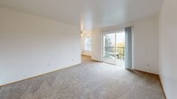 This well-organized 1-bedroom, 1-bathroom home makes efficient use of its single-floor layout, offering a comfortable and functional living environment. The bright living room features plush carpeting, clean white walls, and a sliding glass door that opens to a private balcony overlooking lush greenery — filling the space with natural light and outdoor views. A ceiling fan adds comfort overhead, while a secondary window further enhances ventilation and brightness.

The combined dining and kitchen area is efficiently designed, featuring light countertops, white appliances, a ceiling fan, and a window that invites additional natural light. The bedroom is a well-proportioned retreat with its own ceiling fan, a window framing tree views, and soft carpeting underfoot.

The bathroom is clean and functional, offering a full tub-shower combination, a single-sink vanity with light countertops, and warm wood-look flooring. Three closets throughout the home provide ample storage options.

A dedicated laundry area with in-unit washer and dryer hookups adds everyday convenience. The hallway connects the spaces seamlessly, with a warm wood-toned door and carpeted flooring maintaining a cohesive, inviting aesthetic throughout this thoughtfully designed home.
