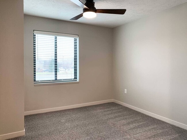 Bright bedrooms feature large windows and ceiling fans for comfort and style. - The Knock Apartments
