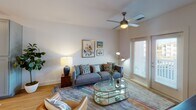 Located at 9124 Charlotte Hwy in Fort Mill, SC, this single-floor residence offers a thoughtfully designed layout that balances comfort and modern style. The living room serves as a welcoming central hub, featuring warm hardwood-style flooring, a ceiling fan with light fixture, and French doors that invite natural light and provide outdoor access. The space is versatile and open, with room for generous seating arrangements and entertainment setup.

The kitchen is a standout feature, showcasing gray shaker-style cabinetry that extends to the ceiling for ample storage, granite countertops with subtle veining, a white subway tile backsplash, and stainless steel appliances including a refrigerator, range, and built-in microwave. The hardwood-style flooring continues seamlessly throughout, reinforcing the cohesive design.

The bedrooms are tranquil retreats with plush carpeting and large windows dressed with sheer curtains that allow soft, diffused natural light while maintaining privacy. One bedroom features a view of the surrounding greenery, enhancing the sense of calm.

The bathroom connects directly to a well-organized walk-in closet outfitted with wire shelving and hanging systems, maximizing storage efficiency. An in-unit washer and dryer are conveniently located within the closet area. The clean, white finishes throughout the bathroom and closet contribute to a bright, airy feel across the entire residence.