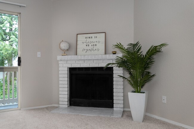 Bayview Apartment Homes Living Room Fireplace and Plant - Bayview Apartment Homes