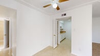 Located at 10631 Pescador Dr in El Paso, TX, this single-story home offers five bedrooms and two bathrooms within a efficiently arranged floor plan. The layout is connected by two hallways that provide smooth circulation throughout the space.

The galley-style kitchen is well-appointed with white cabinetry lining both walls, warm wood-tone countertops, a gas range, refrigerator, and a double sink — all set atop light-toned vinyl tile flooring that keeps the space bright and easy to maintain.

The generously sized primary bedroom stands out as the largest room in the home, featuring ceiling fan with light fixture, louvered closet doors, and light vinyl flooring. Additional bedrooms are carpeted in warm beige tones, with several rooms benefiting from multiple windows fitted with vertical blinds that allow for ample natural light and neighborhood views.

The two bathrooms offer distinct configurations: one features a full tub-shower combo with white square wall tile and chrome fixtures, while the second includes a separate walk-in shower stall alongside a soaking tub, natural light from a window, and tile wainscoting.

A dedicated closet and clean white walls throughout contribute to the home's practical, move-in ready character. The light, neutral palette and consistent flooring choices lend a cohesive look across the entire home.