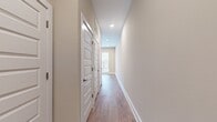 This efficiently designed 530 square foot apartment maximizes space with a thoughtful layout. The single-floor plan encompasses one bedroom measuring 120 square feet, one bathroom, and an open-concept kitchen and living area. The space is characterized by modern finishes and a neutral color palette, creating a bright and airy atmosphere.

The living area, as seen in the image, boasts warm wood-tone flooring that extends throughout the apartment, providing a cohesive look. Recessed lighting fixtures are strategically placed to illuminate the space evenly. A standout feature is the large window with horizontal blinds, allowing for abundant natural light and easy light control.

The walls are painted in a soft, neutral tone, offering a blank canvas for personal decor. Crown molding and baseboards add a touch of elegance to the room. While compact, the thoughtful design ensures each area of the apartment serves a purpose, from the functional kitchen to the cozy bedroom and essential bathroom. The inclusion of a closet adds valuable storage space, crucial in a smaller living environment.