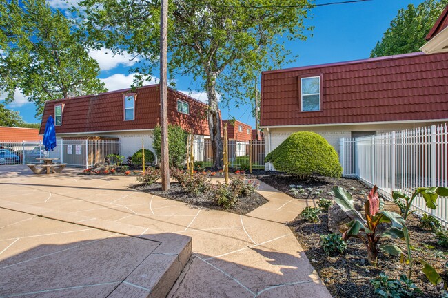 Enjoy a beautifully landscaped community with unique architecture and inviting walkways. - Tucasa Townhomes