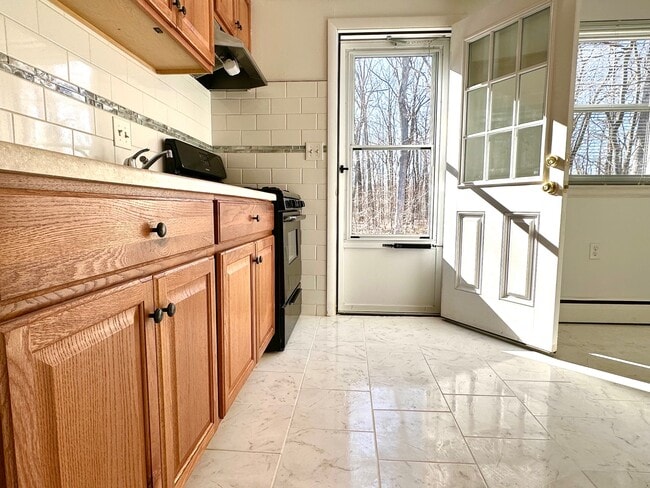 Kitchen opens to wooded yard - 1310 Slater Rd Townhome