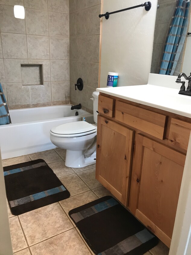 Shared bath with shower/tub combination and a nice white countertop. Ceramic tile floor. - 175 Divot Dr