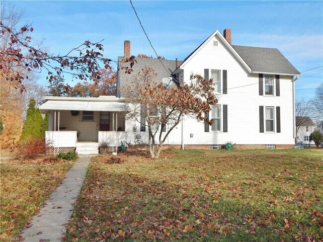 Side of house with porch entrance - facing Grant street - 597 South Broadway