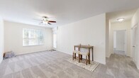 Located at 4229 Stonecrest Dr in Burlington, NC, this single-story, 2-bedroom, 2-bathroom home offers a thoughtfully organized layout designed for comfortable everyday living. The open living room features neutral-toned carpet, a ceiling fan with light fixture, and multiple windows fitted with blinds that allow ample natural light to fill the space, creating a bright and airy atmosphere.

The galley-style kitchen is well-appointed with warm honey-toned cabinetry, granite-look countertops, a double stainless steel sink, and black appliances including an electric range, built-in microwave, and dishwasher. Wood-look flooring ties the kitchen together with a clean, practical finish.

The generously sized primary bedroom offers plush carpeting, a ceiling fan, and a walk-in closet equipped with wire shelving for ample storage. The second bedroom mirrors the same comfortable, carpeted design with natural light from a window. Both bathrooms feature warm wood vanities, white countertops, and large mirrors.

A dedicated laundry room comes ready with washer and dryer hookups, adding functional convenience. The home is completed by a walk-in closet with full wire shelving systems, ensuring storage is never a concern. The overall palette of soft whites and warm neutrals gives the home a clean, welcoming feel throughout.