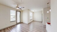 Located in Richmond, TX (77407), this well-appointed single-floor residence offers 1 bedroom, 2 bathrooms, and a thoughtfully designed layout that maximizes comfort and functionality. The living room features light wood-look flooring, a ceiling fan, and multiple windows with natural light, along with a glass door that provides outdoor access and views. The kitchen is a standout feature, equipped with rich dark-wood cabinetry, granite countertops, stainless steel appliances including a French door refrigerator, microwave, and range, plus a peninsula with a double sink — ideal for both cooking and entertaining. The spacious bedroom includes plush carpeting, a ceiling fan, a window with natural light, and direct access to one of the two bathrooms. The primary bathroom features wood-look tile flooring, a dark-wood vanity with granite countertops, a large mirror, and a full soaking tub with shower. The second bathroom is a practical half-bath. A dedicated laundry area includes an in-unit top-load washer and overhead shelving for added storage. A closet provides additional organizational space. Throughout the home, neutral tones and consistent finishes create a clean, cohesive aesthetic.