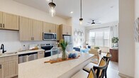 Located at 2220 Berryhill Road in Charlotte, NC, this thoughtfully designed one-bedroom, one-bathroom residence delivers a modern living experience within a well-organized, single-floor layout. The open-concept living, dining, and kitchen area serves as the heart of the home, where light wood-tone cabinetry, quartz countertops, a large central island with bar seating, and stainless steel appliances — including a range, microwave, dishwasher, and refrigerator — combine for a functional and attractive kitchen. Pendant lighting above the island and recessed ceiling lights add warmth and definition to the space. The living area benefits from large windows that invite generous natural light and features a ceiling fan for year-round comfort. The bedroom is a calm retreat, offering ample room, a ceiling fan, large windows, and direct access to a well-appointed closet with built-in wire shelving systems. A second closet provides additional storage. The bathroom includes a tub-shower combination with tiled surround, a quartz-topped vanity, and matte black fixtures. A dedicated laundry area and utility room add practical convenience. Light wood-style flooring flows throughout, tying together the clean, contemporary aesthetic of the entire residence.