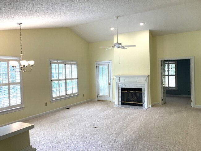 Spacious living room features fireplace and vaulted ceiling - 1243 Cranebridge Pl