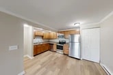 Located at 508 Ivy Ridge Rd in Syracuse, NY, this one-bedroom, one-bathroom unit offers a well-organized and functional layout across a single floor. The living room is a bright, open space featuring hardwood-style flooring, crown molding, and a large sliding glass door that floods the room with natural light and provides outdoor access. A wall-mounted air conditioning unit and baseboard heating ensure year-round comfort.

The kitchen is well-appointed with warm honey-toned cabinetry, granite-style countertops, and a full suite of stainless steel appliances including a refrigerator, electric range, microwave, and dishwasher. Light hardwood-style flooring and crown molding carry through here as well, and a convenient closet is located just off the kitchen area.

The bedroom is a generously sized, carpeted retreat with a large window offering outdoor views and natural light, complemented by baseboard heating. Two closets throughout the unit provide ample storage.

The bathroom features tile flooring, a tiled tub/shower combination with a decorative mosaic accent border, a wood-framed vanity mirror, and a single-sink vanity. The overall aesthetic throughout the unit is clean and neutral, with beige tones and white trim creating a cohesive, move-in-ready environment.