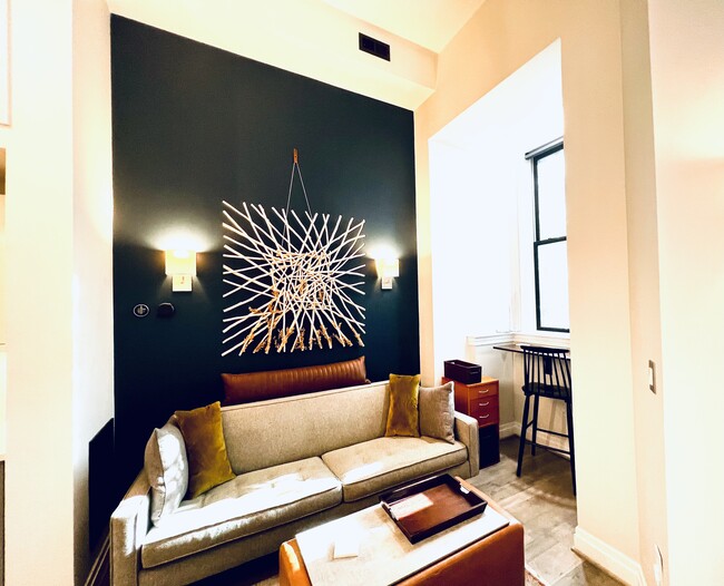 Furnished living room with wall mounted desk with city view. - 1431 11th St NW