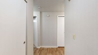 Located at 805 112th St SE in Everett, WA, this single-floor, 2-bedroom, 2-bathroom residence offers a well-organized layout designed for comfortable everyday living. The open living, dining, and kitchen area serves as the heart of the home, featuring warm wood-look flooring, a ceiling fan, and a classic fireplace with a white mantel — an inviting focal point for the living space. Sliding glass doors lead to a private patio, filling the area with natural light and offering pleasant outdoor views. The galley-style kitchen is efficiently designed with white cabinetry, light countertops, a stainless sink, and black appliances including a refrigerator, range, microwave, and dishwasher. A pantry adds valuable storage. Both bedrooms are carpeted and offer closet space, with the primary bedroom providing a generous footprint. The two full bathrooms are clean and functional, each featuring a tub-shower combination and wood-look flooring. A hallway connects the private areas of the home, which also includes an impressive seven closets throughout for abundant storage. The neutral color palette and practical finishes create a move-in-ready environment suitable for a variety of lifestyles.