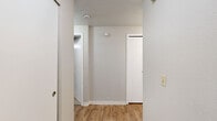 Located at 805 112th St SE in Everett, WA, this single-floor, 2-bedroom, 2-bathroom residence offers a well-organized layout designed for comfortable everyday living. The open living, dining, and kitchen area serves as the heart of the home, featuring warm wood-look flooring, a ceiling fan, and a classic fireplace with a white mantel — an inviting focal point for the living space. Sliding glass doors lead to a private patio, filling the area with natural light and offering pleasant outdoor views. The galley-style kitchen is efficiently designed with white cabinetry, light countertops, a stainless sink, and black appliances including a refrigerator, range, microwave, and dishwasher. A pantry adds valuable storage. Both bedrooms are carpeted and offer closet space, with the primary bedroom providing a generous footprint. The two full bathrooms are clean and functional, each featuring a tub-shower combination and wood-look flooring. A hallway connects the private areas of the home, which also includes an impressive seven closets throughout for abundant storage. The neutral color palette and practical finishes create a move-in-ready environment suitable for a variety of lifestyles.