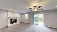 Located at 1139 Tekulve Rd in Batesville, Indiana, this two-floor home offers a well-organized layout with functional living spaces throughout. The main living area is a comfortable, carpeted room anchored by a classic brick fireplace and equipped with a ceiling fan. Sliding glass doors open directly to the outdoors, allowing natural light to fill the space and providing easy access to the backyard greenery visible beyond.

The kitchen features rich, dark cabinetry paired with light granite countertops and wood-look flooring, creating a modern contrast. A stainless steel refrigerator and ample cabinet storage complete the space.

The bedrooms are carpeted and include ceiling fans, with windows that bring in natural light. Closets offer built-in shelving and hanging rods for organized storage. Neutral gray walls throughout the home provide a clean, versatile backdrop.

The bathrooms are finished with warm, stone-look tile flooring and tiled tub surrounds. One bathroom includes a dark wood vanity with a white countertop and a framed mirror, while another is appointed with a tub-shower combination and coordinating tile work.

The home's consistent use of neutral tones, practical finishes, and thoughtful layout make it a straightforward and functional residence in a residential Batesville neighborhood.