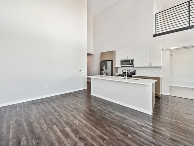 Spacious living room in the 2 Bedroom w/ Loft - 24Fifty at University Park - Historical Ac...