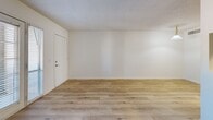 Located at 5755 E River Rd in Tucson, AZ, this one-bedroom, one-bathroom unit offers a clean and functional single-floor layout designed for comfortable everyday living. Light wood-style flooring runs throughout the entire space, creating a cohesive and bright atmosphere.

The combined kitchen and living area forms the heart of the unit. The galley-style kitchen is efficiently designed, featuring warm wood cabinetry, dark granite-style countertops, black appliances including a refrigerator, electric range, over-the-range microwave, and a dishwasher. A pass-through opening connects the kitchen to the living area, enhancing the sense of openness. The living room benefits from a pendant light fixture and access to natural light via a window and exterior door.

The bedroom is a well-proportioned retreat, featuring the same light wood flooring and notably two sets of sliding panel closets, providing generous storage space. The clean white walls and textured ceilings are consistent throughout the unit.

The bathroom is neatly appointed with white cabinetry, a dark countertop vanity, and a wall-mounted sconce light. A hallway with a thermostat connects the main living areas to the bedroom and bathroom. The overall ambiance is fresh, minimal, and move-in ready.