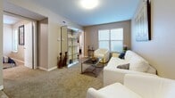 Located at 700 S Haverhill Rd in El Dorado, Kansas, this single-floor unit offers a well-designed layout with comfortable living spaces throughout. The living room serves as the heart of the home, featuring plush carpeting, a large window that invites natural light, and ample space for seating and entertaining. A mirrored glass display cabinet adds a decorative focal point to the room.

The kitchen is outfitted with warm wood cabinetry, dark stone-accented countertops, and black appliances including a full-size refrigerator and range. Stone-look tile flooring runs throughout the kitchen and bathrooms, providing a practical and cohesive design element.

Two well-proportioned bedrooms, each with carpet flooring and natural light from individual windows, offer comfortable and private retreats. Both rooms include closet space and are finished with neutral wall tones that create a calm and versatile atmosphere.

The bathrooms feature warm wood vanities with white countertops, large mirrors, and the same stone-look tile flooring found in the kitchen, creating a consistent and clean aesthetic. Six-panel white interior doors are found throughout the unit, contributing to a tidy, uniform finish. Overall, the space presents a practical and inviting environment suited for everyday living.