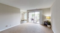 Located at 1491 Druid Valley in Atlanta, GA, this single-floor, one-bedroom, one-bathroom residence offers a thoughtfully organized layout designed for comfortable everyday living. The open living area is finished with plush neutral carpeting and painted in soft, warm tones that create a bright and welcoming ambiance. Large sliding glass doors lead directly to a private balcony, flooding the space with natural light and offering pleasant views of surrounding greenery. Adjacent to the living area is a dedicated dining space, distinguished by wood-look flooring and an elegant chandelier overhead, with an arched window adding architectural character. The bedroom is a comfortable, carpeted retreat featuring a ceiling fan, an arched window with outdoor views, and ample space for furnishings. The kitchen is equipped with rich dark cabinetry, light stone-tone countertops, a gas range, dishwasher, and stainless steel sink — providing a functional and stylish cooking environment. The bathroom is clean and well-appointed, featuring a tiled tub-shower combination, a dark wood vanity with a light countertop, and wood-look flooring. Throughout the unit, neutral walls, consistent flooring transitions, and abundant natural light contribute to a cohesive and inviting atmosphere.