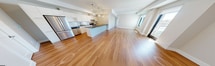 This contemporary 970 sq ft, 2-bedroom, 2-bathroom condo at 1325 Riverbend Rd in London, Ontario offers a clean, modern aesthetic throughout. Warm hardwood flooring flows seamlessly across the entire unit, creating a cohesive and inviting atmosphere. The open-concept kitchen and living area serves as the heart of the unit, featuring a large island with a dark countertop, sleek white cabinetry, a subway tile backsplash, and a full suite of stainless steel appliances — including a French door refrigerator, dishwasher, and electric range. Three globe pendant lights hang above the island, adding a stylish focal point. The living area is bright and airy, with multiple windows and a glass door leading to a private balcony with outdoor views. Both bedrooms are well-proportioned and filled with natural light; the primary bedroom measures 130 sq ft and includes a dedicated walk-in closet with built-in shelving, while the second bedroom features a double sliding-door closet. The two bathrooms are finished to a high standard, with marble-style tile, a warm wood vanity, and a deep soaker tub with a handheld shower. A hallway connects all rooms efficiently, completing this well-designed modern residence.