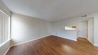 Located at 5902 Boulder Creek Ct in Hazelwood, Missouri, this two-floor residence offers a practical and comfortable layout with consistent finishes throughout. The main living area features warm hardwood-style flooring and neutral-toned walls, creating a bright and open atmosphere. A distinctive pass-through window connects the living room to the kitchen, enhancing the sense of openness between spaces. The kitchen is appointed with wood cabinetry, granite-style countertops, a double-basin stainless steel sink, and white appliances including a refrigerator and range, all set over matching hardwood-style flooring. Multiple vertical-blind windows in the living areas allow ample natural light to filter through. The bedrooms are finished with plush wall-to-wall carpeting and feature windows with views to the outdoors, providing a calm and comfortable retreat. The bathroom includes a full soaking tub and shower combination, wood cabinetry with overhead storage, granite-style countertops, and hardwood-style flooring, maintaining a cohesive design language found throughout the home. Overall, the space presents a clean, functional interior with warm tones and practical finishes across both floors.