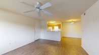 Located at 12450 Biscayne Blvd in Jacksonville, FL, this one-bedroom, one-bathroom unit offers a practical and comfortable single-floor layout. The open living area is finished with warm wood-look flooring and features a ceiling fan, creating a bright and airy atmosphere. A large window allows natural light to fill the space and provides outdoor views, enhancing the overall sense of openness.

The kitchen is semi-open to the living room via a pass-through counter, offering both functionality and connectivity. It is equipped with warm-toned wood cabinetry, light countertops, a dishwasher, electric range, and a full-size refrigerator, with ample upper and lower cabinet storage along both walls.

The generously sized bedroom is carpeted for comfort and features dual windows that invite natural light and outdoor views, along with a ceiling fan overhead. A dedicated closet provides convenient storage.

The bathroom is clean and efficient, featuring a combined tub and shower with tile surround, a single-sink vanity with a mirror, and wood-look flooring that ties the space together cohesively. Throughout the unit, neutral wall tones and consistent flooring choices create a cohesive and move-in-ready aesthetic.