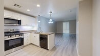 Located at 102 N Lemon Ave in Ontario, CA, this well-appointed one-bedroom, one-bathroom unit offers a thoughtfully designed single-floor layout. The open-concept living and dining area flows seamlessly from the kitchen, creating a bright and cohesive communal space. Light gray luxury vinyl plank flooring runs throughout, complementing the neutral wall tones for a clean, modern aesthetic.

The kitchen is a standout feature, showcasing white shaker-style cabinetry, granite countertops, and a peninsula with additional seating and prep space. A full suite of stainless steel appliances includes a gas range, over-the-range microwave, dishwasher, and refrigerator. Pendant lighting and recessed fixtures provide layered illumination throughout the cooking space.

The living area is anchored by a large window with vertical blinds, allowing ample natural light to filter in. The spacious bedroom includes a ceiling fan, a generous closet, and its own large window. Additional storage is provided through three closets found throughout the unit.

The bathroom features a clean, white tub/shower combo with recessed lighting and vinyl plank flooring. A dedicated laundry area and private balcony round out the functional amenities, making this a complete and comfortable residential unit.