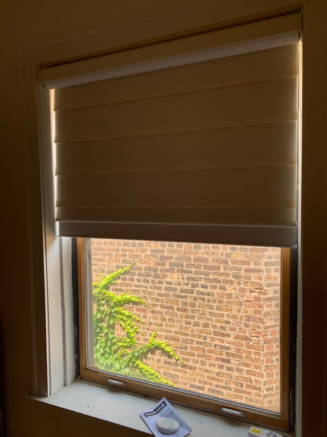 Light blocking, electronically powered shade in Primary Bedroom - 4938 N Washtenaw Ave