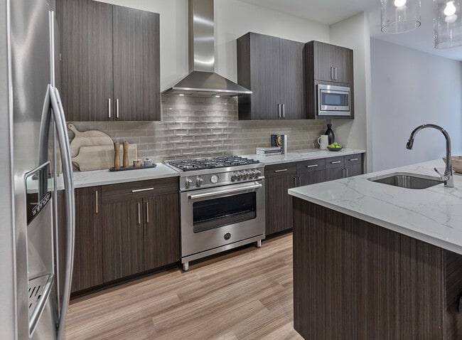 Experience elegance in this penthouse with upgraded kitchen appliances, including 36" Bertazzoni range, designed for style and functionality. - 30 Court Street Apartments