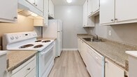 This 1-bedroom, 1-bathroom unit in Citrus Heights, CA offers a thoughtfully designed single-level layout that maximizes comfort and functionality. The living and dining areas are open and airy, featuring light-toned hardwood-style flooring, neutral gray walls, and a textured ceiling. Large sliding glass doors flood the living space with natural light and open to a private balcony with outdoor views of surrounding trees, complemented by an additional window and a ceiling fan for added comfort. The galley-style kitchen is efficiently laid out with white cabinetry, granite-look countertops, and white appliances, including a range and refrigerator. The spacious bedroom features plush carpeting, two generously sized sliding-door closets with built-in shelving, natural light from dual windows, and direct access to the bathroom. The full bathroom is clean and functional, with a tub/shower combo, a vanity with granite-look countertops, and hardwood-style flooring. Hallways connect the rooms seamlessly, providing additional storage closets throughout. The unit's neutral color palette and updated finishes create a cohesive, move-in-ready ambiance suited for comfortable everyday living.