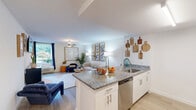 Located at 500 Merrimac Trail in Williamsburg, VA, this three-bedroom, one-bathroom unit offers a well-planned single-floor layout that makes efficient use of its space. Light wood-style flooring runs throughout, creating a cohesive and clean aesthetic across every room.

The living room serves as the heart of the home, featuring a ceiling fan, large window with outdoor views of lush greenery, and ample room for comfortable seating arrangements. The kitchen is equipped with stainless steel appliances, including a refrigerator, range, and microwave, complemented by white cabinetry, a tile backsplash, and granite countertops that extend to a peninsula with an undermount sink — ideal for both cooking and casual dining.

The primary bedroom offers a ceiling fan, a window with natural light, and a generous walk-in closet with built-in wire shelving. Additional bedrooms provide flexible space, with one suitable for use as a home office or study. The shared bathroom features a granite-topped vanity with an undermount sink, white cabinetry, and a shower-tub combination. Two hallways connect the rooms efficiently, adding to the overall flow of the layout. This unit combines practical design with modern finishes throughout.