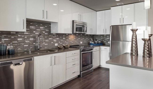 Modern kitchen featuring quartz countertops and stainless steel appliances - Indigo