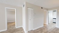 This single-floor residence offers a clean, move-in-ready interior defined by a consistent neutral color palette, wood-look plank flooring, and textured ceilings throughout. The open living area is generously proportioned, benefiting from large windows fitted with horizontal blinds that allow ample natural light to fill the space. A front entry door with an adjacent window further enhances the bright, airy feel of the main living zone.

The kitchen is well-equipped and thoughtfully updated, featuring white shaker-style cabinetry both above and below the counters, bright white quartz-style countertops, and a classic subway tile backsplash. A stainless steel double-basin sink sits beneath a window, and a stainless steel electric range with an overhead exhaust hood completes the functional cooking space.

The bedrooms are comfortable and well-lit, each showcasing the same wood-look flooring and neutral wall tones, with windows providing natural light and a calm atmosphere. A closet with louvered bifold doors offers convenient storage in one of the rooms.

The bathrooms include a full bath with a tub-shower combination featuring tiled surround walls, and a second bath with a standalone walk-in shower enclosed by a sliding glass door, a single-sink vanity with white cabinetry, and wood-look flooring. Both bathrooms maintain the home's clean, updated aesthetic.