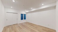 Located at 901 Leland St in Philadelphia's Fairmount neighborhood, this efficiently designed single-floor unit makes excellent use of its intimate footprint. The open-plan kitchen and living area serves as the heart of the space, featuring light-toned hardwood flooring, crisp white walls, and recessed lighting throughout. A sliding barn-style door adds a modern touch while maximizing usable floor space. Natural light filters in through a window dressed with blue blinds, contributing to the bright, clean aesthetic.

The kitchen is well-appointed with white shaker cabinetry accented by matte black hardware, stainless steel appliances including a full-size refrigerator, electric range, built-in microwave, and dishwasher. A marble-look tile backsplash and light quartz countertops complete the polished look.

The bathroom continues the refined design language with striking marble-look tile lining the tub surround from floor to ceiling, complemented by matte black fixtures and a full soaking tub with overhead shower. A dedicated closet and in-unit laundry add practical convenience. Throughout the space, the consistent use of light materials and recessed lighting creates a cohesive, modern ambiance.