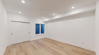 Located at 901 Leland St in Philadelphia's Fairmount neighborhood, this efficiently designed single-floor unit makes excellent use of its intimate footprint. The open-plan kitchen and living area serves as the heart of the space, featuring light-toned hardwood flooring, crisp white walls, and recessed lighting throughout. A sliding barn-style door adds a modern touch while maximizing usable floor space. Natural light filters in through a window dressed with blue blinds, contributing to the bright, clean aesthetic.

The kitchen is well-appointed with white shaker cabinetry accented by matte black hardware, stainless steel appliances including a full-size refrigerator, electric range, built-in microwave, and dishwasher. A marble-look tile backsplash and light quartz countertops complete the polished look.

The bathroom continues the refined design language with striking marble-look tile lining the tub surround from floor to ceiling, complemented by matte black fixtures and a full soaking tub with overhead shower. A dedicated closet and in-unit laundry add practical convenience. Throughout the space, the consistent use of light materials and recessed lighting creates a cohesive, modern ambiance.
