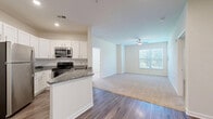 Located at 4115 S Lee St in Buford, GA, this single-floor, 2-bedroom, 2-bathroom home offers a well-planned layout with a clean, modern aesthetic. The open-concept kitchen is a standout feature, showcasing white shaker cabinetry, granite countertops, a subway tile backsplash, and a full suite of stainless steel appliances including a refrigerator, electric range, and over-the-range microwave. A peninsula with matching granite provides additional counter space and opens to the main living area, all finished with durable wood-style plank flooring.

The spacious primary bedroom features plush carpeting, a ceiling fan, dual windows that invite natural light and outdoor views, and direct access to a dedicated closet. The second bedroom is also carpeted and naturally lit. Both bathrooms are finished with granite-topped white vanities and wood-style flooring. One bathroom includes a soaking tub and tub-shower combination, while the other features a walk-in shower with grab bars and a built-in bench. The home also includes a dedicated laundry area, two closets for ample storage, and a connecting hallway that ties all spaces together efficiently.