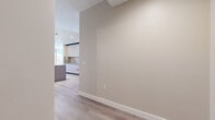 Located at 520 N Central Ave in Glendale, CA, this well-appointed single-floor residence offers three bedrooms and two bathrooms across a generously sized, thoughtfully designed layout. The interior is defined by light-toned hardwood flooring that flows seamlessly throughout, complemented by warm neutral walls and crisp white trim that create a clean, contemporary aesthetic.

The open-concept living and dining area is a standout feature, bathed in natural light through expansive floor-to-ceiling windows. The kitchen is outfitted with modern cabinetry in soft tones, stainless steel appliances, a striking kitchen island with wood-paneled detailing, and track lighting overhead. A set of louvered double doors adds a classic architectural touch near the main living space.

Each bedroom is well-proportioned, offering ample closet space with sliding doors and large windows that invite sunlight throughout the day. The primary bedroom is particularly spacious, providing room for substantial furnishings.

The two bathrooms are finished to a high standard. One features rich brown marble-tiled walls, a soaking tub, glass enclosure, and a walnut-toned vanity. The second bathroom offers a frameless glass walk-in shower with light stone tile, a rainfall showerhead, and a matching walnut vanity with a white quartz countertop. Three hallways provide efficient connectivity throughout the residence.