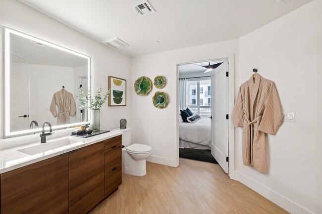 Warm wood vanity with unique bathroom layout - AMLI Aero Apartments