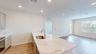 Located at 2966 Linden St in Bethlehem, PA, this well-appointed 3-bedroom, 2-bathroom single-floor home offers a clean, modern aesthetic throughout. Light-toned luxury vinyl plank flooring flows through the main living areas, while plush carpet adds comfort to each bedroom. The open-concept kitchen is a standout feature, boasting striking marble-look quartz countertops with a waterfall peninsula, gray shaker-style cabinetry, recessed lighting, and a full suite of stainless steel appliances including a refrigerator, range, microwave, and dishwasher. The kitchen flows seamlessly into the bright living room, which is filled with natural light from large windows and a glass door leading to a private balcony. The primary bedroom is generously sized with multiple windows and a ceiling fan, while the additional bedrooms feature plush carpeting and garden views. The primary bathroom offers a dual-sink vanity with modern fixtures and a glass-enclosed shower, while the second bathroom includes a tub-shower combination. Three closets provide ample storage. A dedicated laundry area rounds out this thoughtfully designed home.