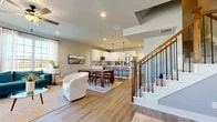 Located at 2005 S Forum Dr in Grand Prairie, TX, this well-designed three-story home offers 3 bedrooms and 4 bathrooms thoughtfully distributed across three levels. The main living floor presents an open-concept layout where the living room, dining area, and kitchen flow seamlessly together. Light wood-look flooring, recessed lighting, and neutral gray walls create a bright, contemporary atmosphere throughout. The kitchen is a standout feature, showcasing white shaker cabinetry with matte black hardware, quartz countertops, a hexagonal tile backsplash, and stainless steel appliances, including a French door refrigerator. A dedicated dining space sits adjacent to the kitchen, while a staircase with wood-and-iron balusters connects each floor. The upper levels house the bedrooms, each carpeted and filled with natural light from large windows. The primary bedroom offers a comfortable, well-proportioned retreat. A second living room on the upper level is bright and spacious, with oversized windows providing broad outdoor views. The four bathrooms are finished with clean, modern tile work, including tub-shower combinations with subway-style surround tile and matte black fixtures. A dedicated laundry area with upper cabinetry adds practical convenience. The home's consistent use of neutral tones, modern finishes, and multi-level design make it a functional and stylish residence.