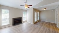 Located at 20 Mason Dr in Red Bank, Tennessee, this single-floor home offers a well-designed layout with a clean, neutral aesthetic throughout. The living area is a standout space, featuring vaulted ceilings, light hardwood-style flooring, and a tile-surround fireplace that serves as a focal point. Multiple windows allow natural light to fill the room, while a ceiling fan adds both style and function. A pass-through opening connects the living area to the kitchen, enhancing the open feel of the space. The kitchen is thoughtfully updated with white shaker-style cabinetry, light quartz countertops, a classic subway tile backsplash, and a full suite of stainless steel appliances including a refrigerator, dishwasher, range, and microwave. The bedroom continues the home's consistent style with hardwood-style flooring, a ceiling fan, and a bright window with blinds. The bathroom features a full tub and shower combination with white tile surround and modern brushed nickel fixtures. A dedicated laundry area with built-in shelving provides practical in-unit convenience. Overall, the home presents a bright, move-in-ready atmosphere with modern updates and a functional single-level floor plan.