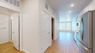 This one-bedroom, one-bathroom unit in Aurora, Colorado offers a thoughtfully organized single-floor layout that makes efficient use of its space. Light wood-style luxury vinyl flooring runs throughout the main living areas, lending a clean, contemporary feel that ties the unit together cohesively.

The combined kitchen and living area forms the heart of the unit. The kitchen is outfitted with gray shaker-style cabinetry, light countertops, a tile backsplash, stainless steel appliances, and recessed lighting overhead. It flows naturally into the living area, which receives natural light through multiple windows fitted with horizontal blinds. A glass door in the living space provides outdoor access and adds additional natural brightness.

A hallway connects the main living area to the private bedroom, bathroom, and closet. The bedroom features neutral carpet flooring, a ceiling fan, and direct access to a dedicated closet with additional storage space. The bathroom maintains the unit's clean aesthetic with gray cabinetry, a white countertop vanity, and wood-style tile flooring. Throughout the unit, white walls and crisp white trim contribute to a bright, move-in-ready atmosphere.
