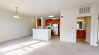 This well-appointed one-bedroom, one-bathroom residence in Rosedale, Maryland offers a thoughtfully designed single-floor layout that maximizes comfort and functionality. The open-concept living and dining area is bathed in natural light streaming through large windows dressed with clean white blinds, creating a bright and welcoming atmosphere. Soft carpeting flows throughout the living spaces, adding warmth underfoot.

The kitchen is a standout feature, anchored by a peninsula with a white countertop that doubles as a breakfast bar. Warm-toned wood cabinetry reaches toward the ceiling for generous storage, while stainless steel appliances — including a refrigerator, range, microwave, and dishwasher — provide a modern, polished look. Wood-look flooring ties the kitchen together seamlessly.

The spacious primary bedroom receives ample natural light through large windows and offers generous room for furnishings, complemented by two closets for storage. The bathroom is well-equipped with a wood-toned vanity, white countertop, a tub-shower combination with tiled surround, and wood-look flooring throughout.

A dedicated in-unit laundry area adds everyday convenience. The overall design balances neutral tones, modern finishes, and practical layout for comfortable residential living.