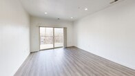 Located at 739 S 300 W in Salt Lake City, Utah, this well-appointed single-floor residence offers three bedrooms and four bathrooms within a thoughtfully designed layout. The open-concept kitchen and living area serves as the heart of the home, featuring warm honey-toned cabinetry, rich wood-finish countertops, stainless steel appliances including a refrigerator and microwave, and a peninsula with an integrated sink — ideal for casual dining and entertaining. Pendant lighting and recessed fixtures illuminate the space, which flows seamlessly onto durable wood-look flooring. The bedrooms are carpeted for comfort, with the generously sized primary bedroom offering ample space and access to a dedicated bathroom complete with a dual-sink vanity, wood-toned cabinetry, warm countertops, and stylish towel bar fixtures. Additional bedrooms feature natural light through windows with outdoor views. The hallways connect rooms efficiently, with tile flooring in transitional areas. A dedicated laundry room houses a full-size washer and dryer beneath built-in cabinetry for added storage. Closets include built-in hanging rods and shelving. Clean white walls and consistent modern finishes throughout create a cohesive, move-in-ready environment.