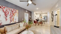 Located at Vineland Resort Way in Orlando, FL, this well-appointed 2-bedroom, 2-bathroom residence offers a thoughtfully designed single-level layout with modern finishes throughout. Light wood-look tile flooring flows seamlessly across the open-concept living and kitchen area, creating a bright and cohesive atmosphere.

The kitchen is a standout feature, boasting crisp white shaker cabinetry, stainless steel appliances including a French door refrigerator, dishwasher, and range, gleaming quartz countertops, a tile backsplash, and a central island with pendant lighting — ideal for both cooking and casual dining.

The living room is a welcoming retreat, filled with natural light from large windows with outdoor views, and anchored by a ceiling fan. A textured accent wall adds depth and character to the space.

The spacious primary bedroom offers generous proportions, large windows with soft drapery, and easy access to a dedicated closet. The second bedroom is equally comfortable and well-lit. Both bathrooms feature white vanity cabinetry, framed mirrors, tile flooring, and clean, modern fixtures — one including a glass-enclosed walk-in shower.

A dedicated laundry room with a full-size washer and dryer adds everyday convenience, completing this stylish and functional Orlando home.